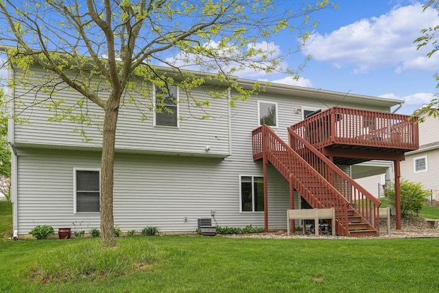 121 W Calgary Dr, Hastings, MI 49058 - back of property with a wooden deck, a lawn, and stairs