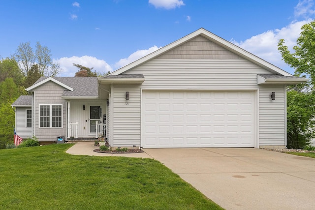 121 W Calgary Dr, Hastings, MI 49058 - single story home with a front yard, driveway, a shingled roof, and a garage