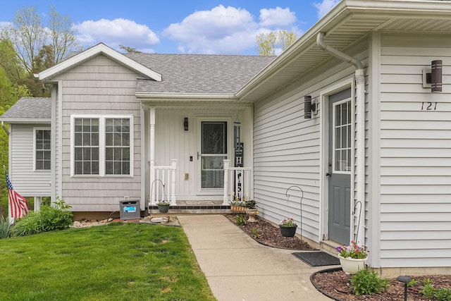 121 W Calgary Dr, Hastings, MI 49058 - property entrance with roof with shingles and a lawn