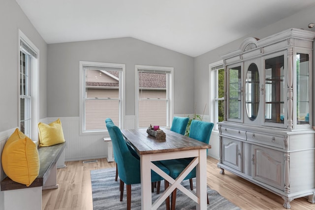 121 W Calgary Dr, Hastings, MI 49058 - dining area with wainscoting, light wood-style flooring, and lofted ceiling