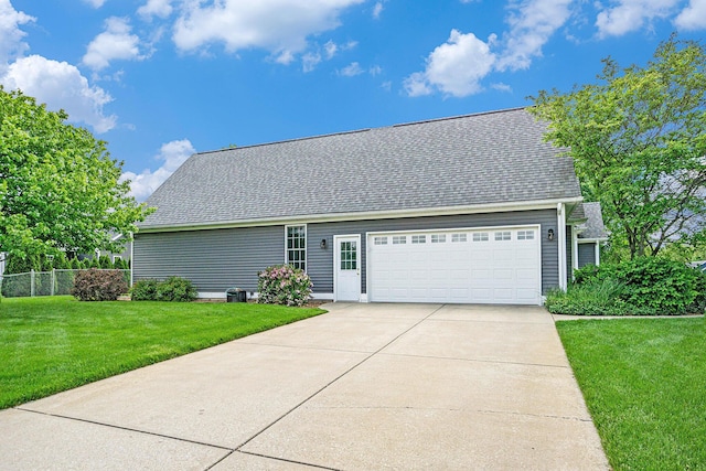 1001 Goodsell St, Otsego, MI 49078 - view of front facade with a garage, driveway, and a shingled roof