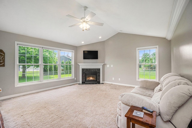 1001 Goodsell St, Otsego, MI 49078 - carpeted living area featuring baseboards, healthy amount of natural light, lofted ceiling, ceiling fan, and a premium fireplace