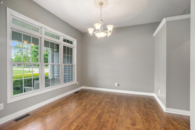 1001 Goodsell St, Otsego, MI 49078 - empty room featuring a chandelier, baseboards, and dark wood-type flooring