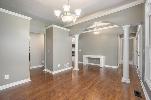 1001 Goodsell St, Otsego, MI 49078 - spare room featuring arched walkways, wood finished floors, baseboards, ornate columns, and crown molding