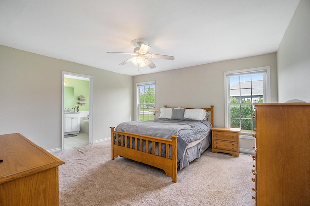 1001 Goodsell St, Otsego, MI 49078 - bedroom featuring light colored carpet, ensuite bathroom, ceiling fan, and baseboards
