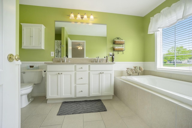 1001 Goodsell St, Otsego, MI 49078 - full bathroom with toilet, tile patterned flooring, wainscoting, double vanity, and a bath