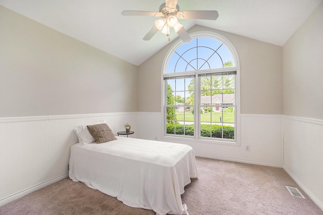 1001 Goodsell St, Otsego, MI 49078 - bedroom featuring wainscoting, light carpet, vaulted ceiling, and a ceiling fan