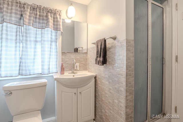 4175 Huntington Ave NE, Grand Rapids, MI 49525 - bathroom featuring tile walls, toilet, a shower stall, and vanity
