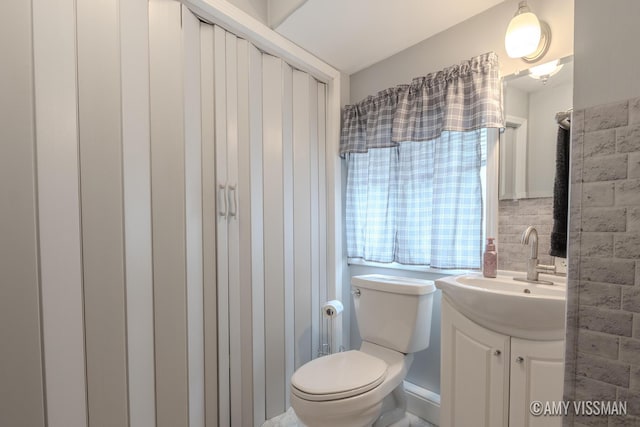 4175 Huntington Ave NE, Grand Rapids, MI 49525 - bathroom with vanity, toilet, and tile walls