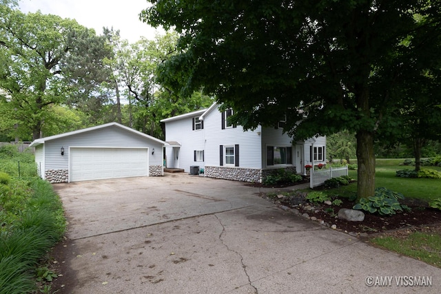 4175 Huntington Ave NE, Grand Rapids, MI 49525 - view of front of house with a garage, an outbuilding, and stone siding