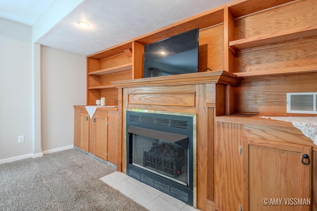 4175 Huntington Ave NE, Grand Rapids, MI 49525 - unfurnished living room featuring a fireplace with flush hearth, baseboards, and carpet floors