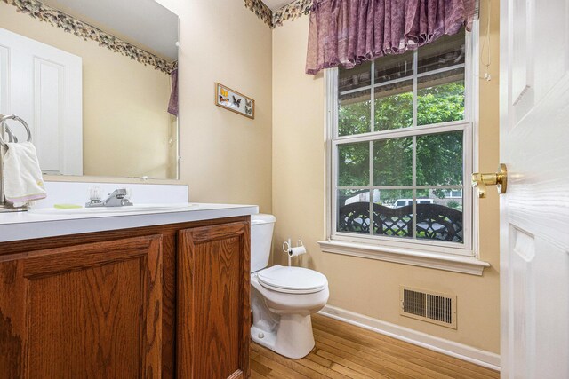 3311 Hickory Dr, Lake Orion, MI 48359 - bathroom featuring baseboards, vanity, wood finished floors, and toilet