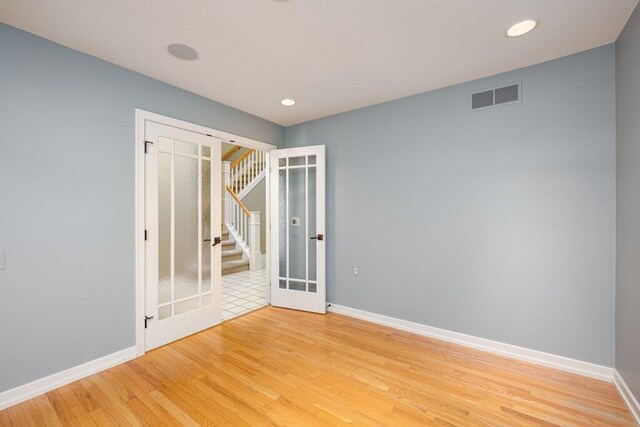4936 Ravine Ct, Ann Arbor, MI 48105 - unfurnished bedroom with baseboards, light wood-style floors, and recessed lighting