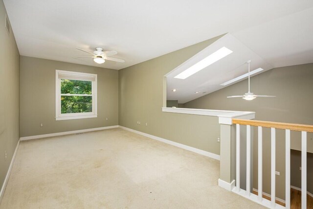 4936 Ravine Ct, Ann Arbor, MI 48105 - carpeted spare room with ceiling fan, lofted ceiling, a skylight, and baseboards
