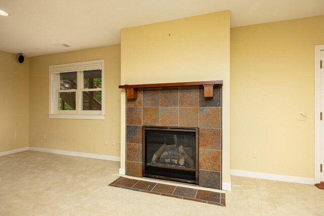 4936 Ravine Ct, Ann Arbor, MI 48105 - detailed view of carpet floors, a tiled fireplace, and baseboards