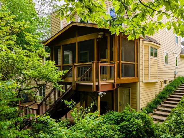 4936 Ravine Ct, Ann Arbor, MI 48105 - rear view of property with stairs, a sunroom, a chimney, and a deck