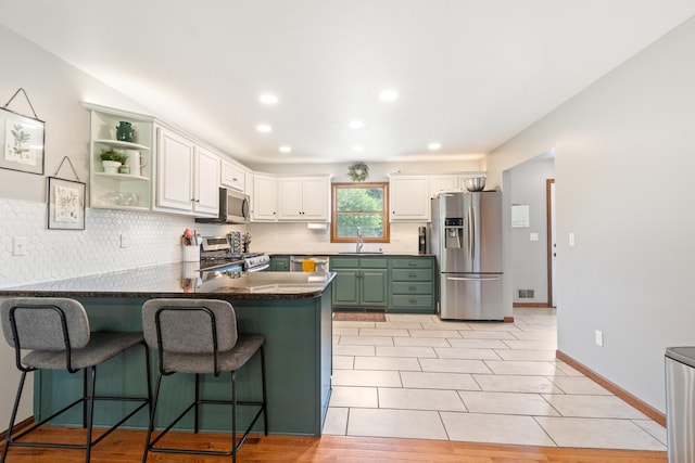 617 Ramsey Ln, Pleasant Lake, MI 49272 - kitchen featuring appliances with stainless steel finishes, a sink, a peninsula, decorative backsplash, and recessed lighting