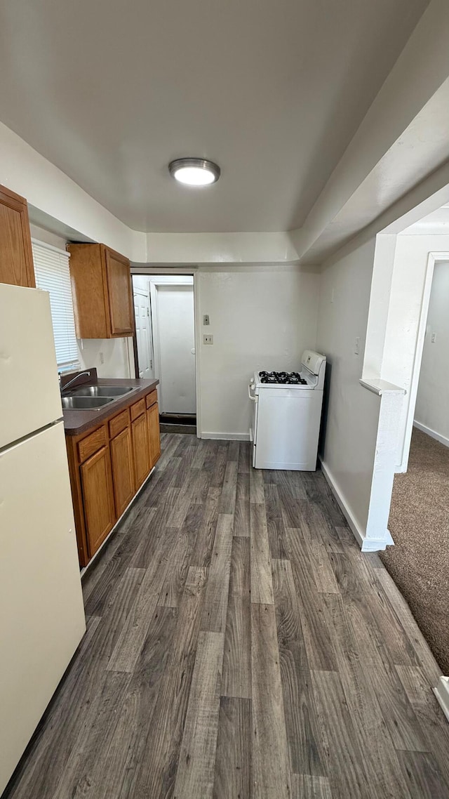 15852 Wabash St, Detroit, MI 48238 - kitchen featuring white appliances, a sink, brown cabinetry, and dark wood finished floors