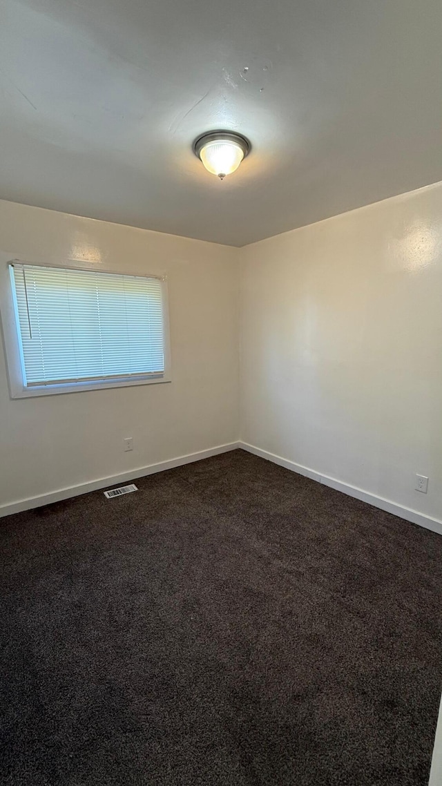 15852 Wabash St, Detroit, MI 48238 - unfurnished room featuring dark colored carpet and baseboards