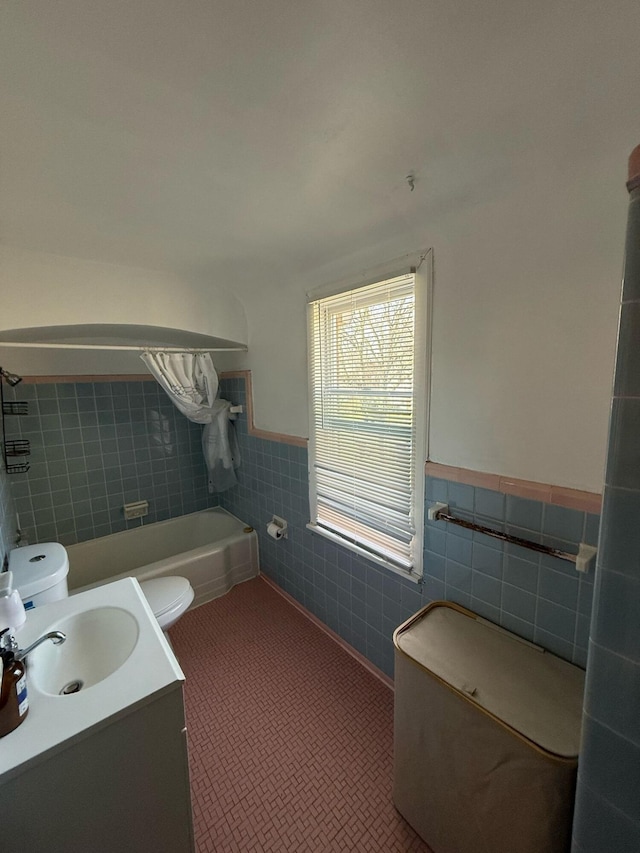 18294 Marlowe St, Detroit, MI 48235 - bathroom with tile walls, toilet, a wainscoted wall, a tub, and vanity