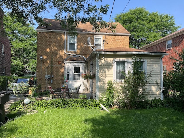 18294 Marlowe St, Detroit, MI 48235 - back of property featuring brick siding, a yard, and a patio