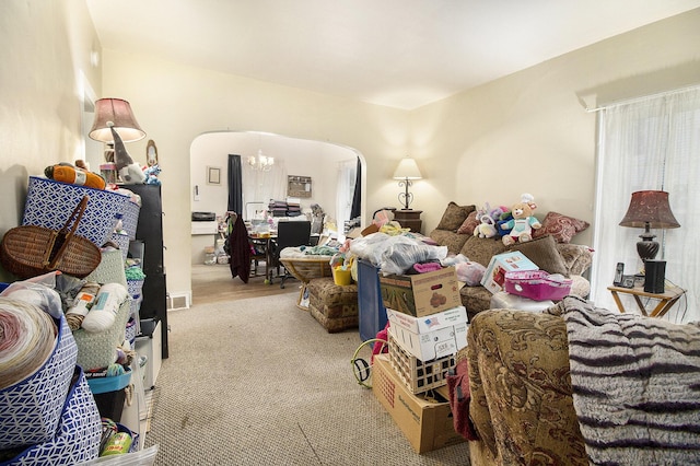 244 W Franklin St, Otsego, MI 49078 - living area featuring arched walkways, carpet flooring, and a chandelier