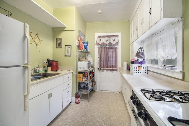 244 W Franklin St, Otsego, MI 49078 - kitchen featuring white appliances, a sink, light countertops, and white cabinets