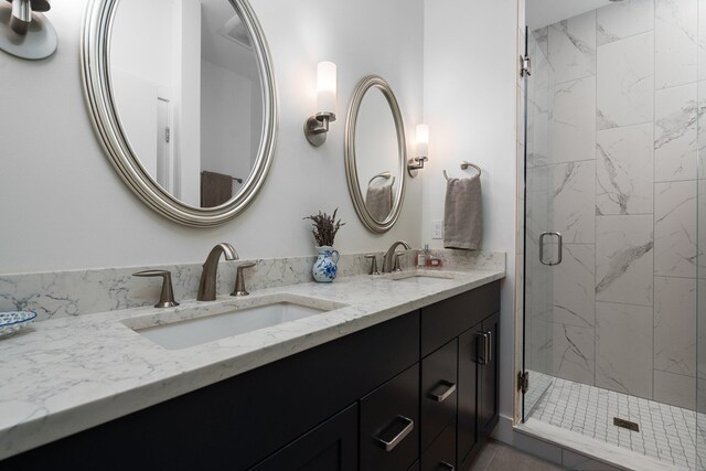 211 W Kingsley St, Ann Arbor, MI 48103 - bathroom featuring double vanity and a marble finish shower