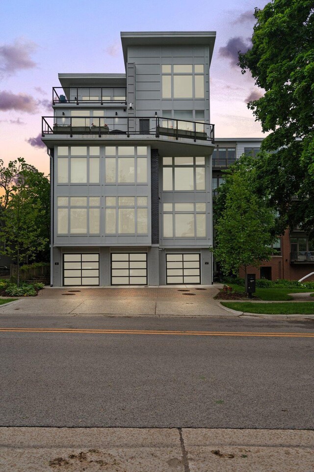 211 W Kingsley St, Ann Arbor, MI 48103 - property at dusk featuring an attached garage and concrete driveway