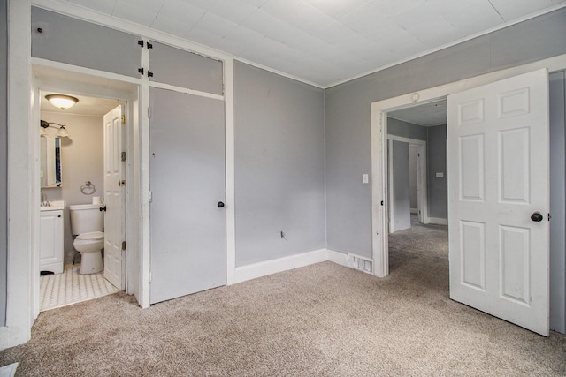 527 Jackson St W, Battle Creek, MI 49037 - unfurnished bedroom featuring carpet flooring, ensuite bath, ornamental molding, and a sink