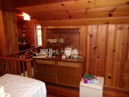 98 Reading Ave, Hillsdale, MI 49242 - bedroom with wood finished floors, wood walls, and lofted ceiling