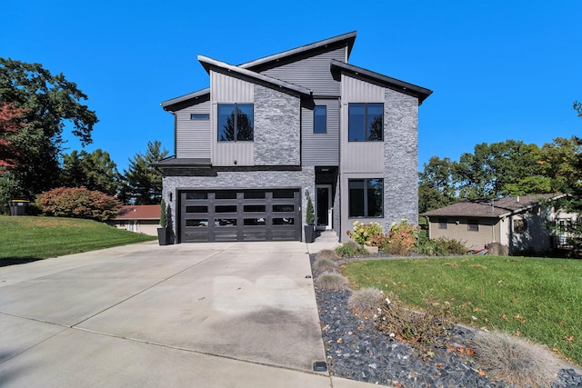 104 Highview Ct, Brooklyn, MI 49230 - modern home featuring concrete driveway, a front yard, and a garage
