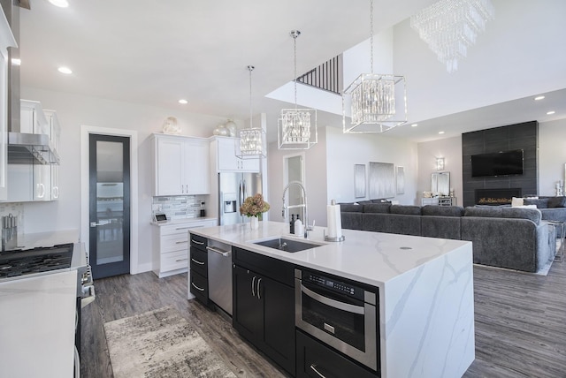 104 Highview Ct, Brooklyn, MI 49230 - kitchen with stainless steel appliances, a sink, a chandelier, dark cabinetry, and dark wood-style flooring