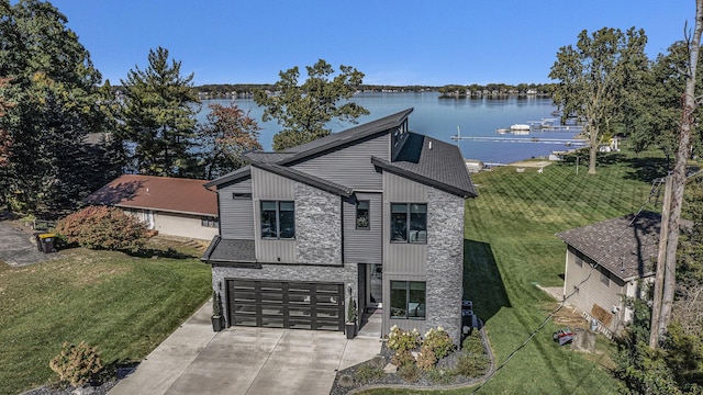 104 Highview Ct, Brooklyn, MI 49230 - view of front of home featuring a water view, driveway, a front yard, and an attached garage