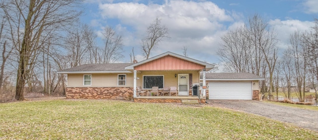 286 S Willowbrook Rd, Coldwater, MI 49036 - single story home featuring covered porch, brick siding, a front yard, an attached garage, and driveway
