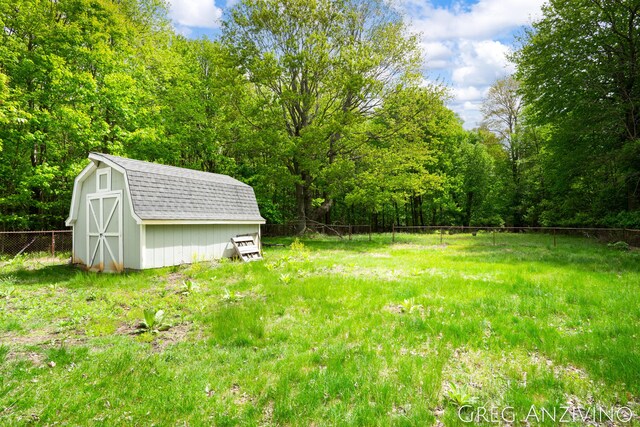5906 Henry St, Norton Shores, MI 49441 - view of yard with a wooded view