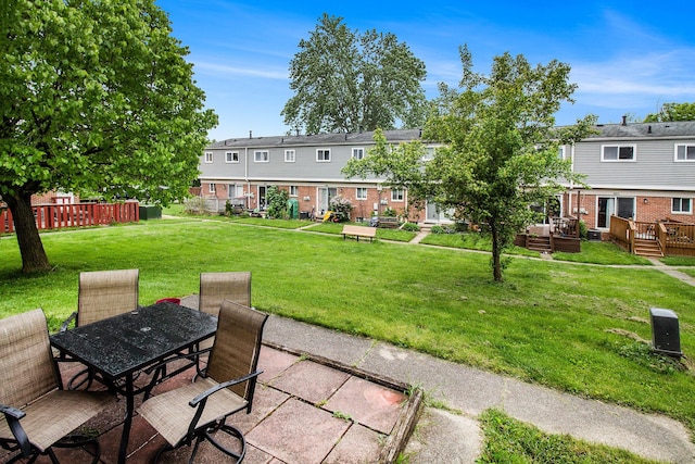 3146 Wolverine Dr, Ann Arbor, MI 48108 - view of green lawn featuring outdoor dining area, a deck, and a residential view