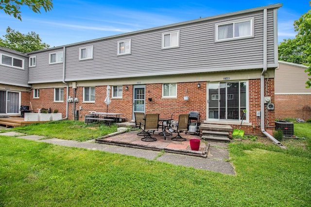 3146 Wolverine Dr, Ann Arbor, MI 48108 - back of property with a yard, cooling unit, brick siding, a patio area, and entry steps