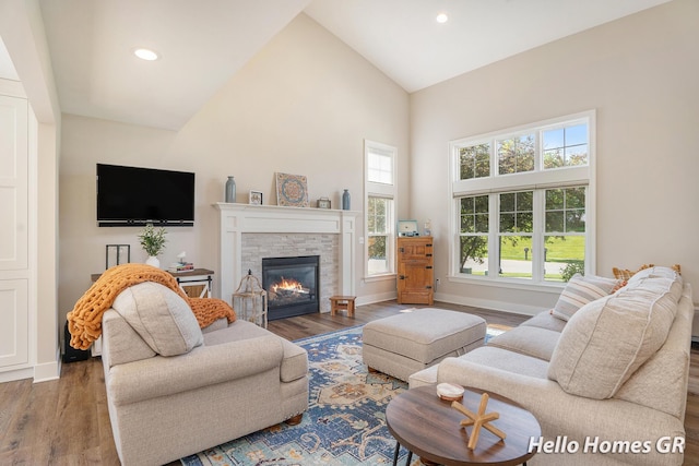 535 N Creek Ct NE, Rockford, MI 49341 - living room featuring high vaulted ceiling, wood finished floors, a fireplace, recessed lighting, and baseboards