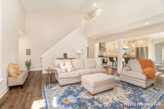 535 N Creek Ct NE, Rockford, MI 49341 - living area featuring wood finished floors, baseboards, recessed lighting, and high vaulted ceiling