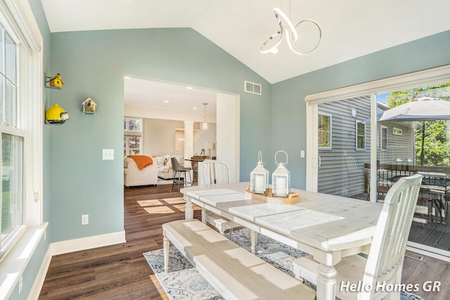 535 N Creek Ct NE, Rockford, MI 49341 - dining room with vaulted ceiling, dark wood-style floors, and baseboards