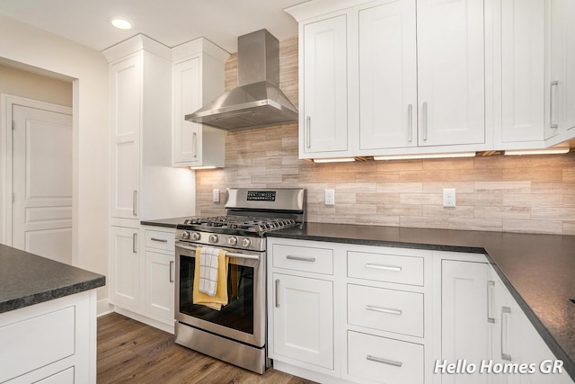 535 N Creek Ct NE, Rockford, MI 49341 - kitchen with stainless steel gas range oven, wall chimney range hood, dark countertops, white cabinetry, and recessed lighting