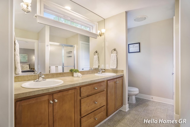 535 N Creek Ct NE, Rockford, MI 49341 - full bath featuring a shower stall, double vanity, connected bathroom, baseboards, and toilet