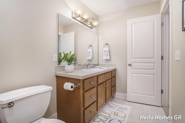 535 N Creek Ct NE, Rockford, MI 49341 - bathroom featuring vanity, toilet, and tile patterned flooring