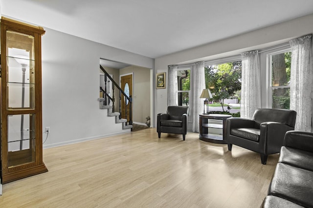 14436 Fairway St, Livonia, MI 48154 - living area featuring light wood-type flooring, stairs, and baseboards