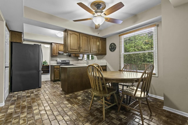 14436 Fairway St, Livonia, MI 48154 - dining space with brick floors, baseboards, and a ceiling fan