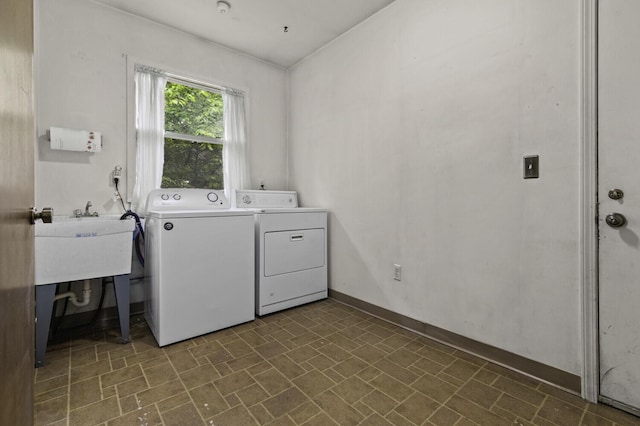 14436 Fairway St, Livonia, MI 48154 - laundry room featuring washer and dryer, brick patterned flooring, and baseboards