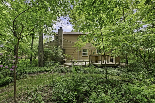 14436 Fairway St, Livonia, MI 48154 - rear view of house with a wooden deck and a chimney