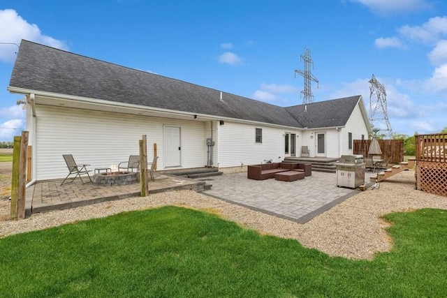 3025 Shawnee Rd, Bridgman, MI 49106 - rear view of property featuring a patio area, an outdoor living space with a fire pit, a yard, and a shingled roof
