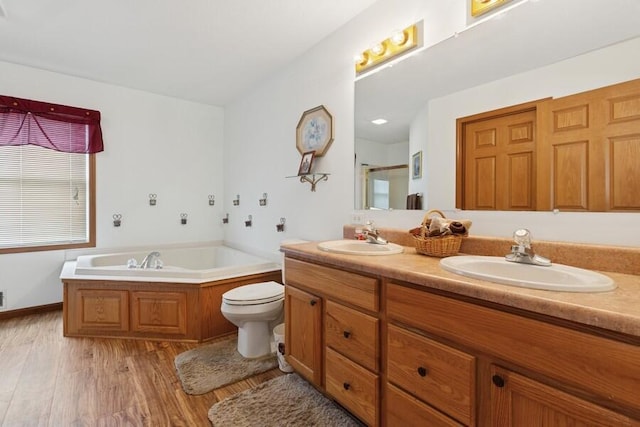 3025 Shawnee Rd, Bridgman, MI 49106 - bathroom with double vanity, wood finished floors, a garden tub, and a shower with shower door